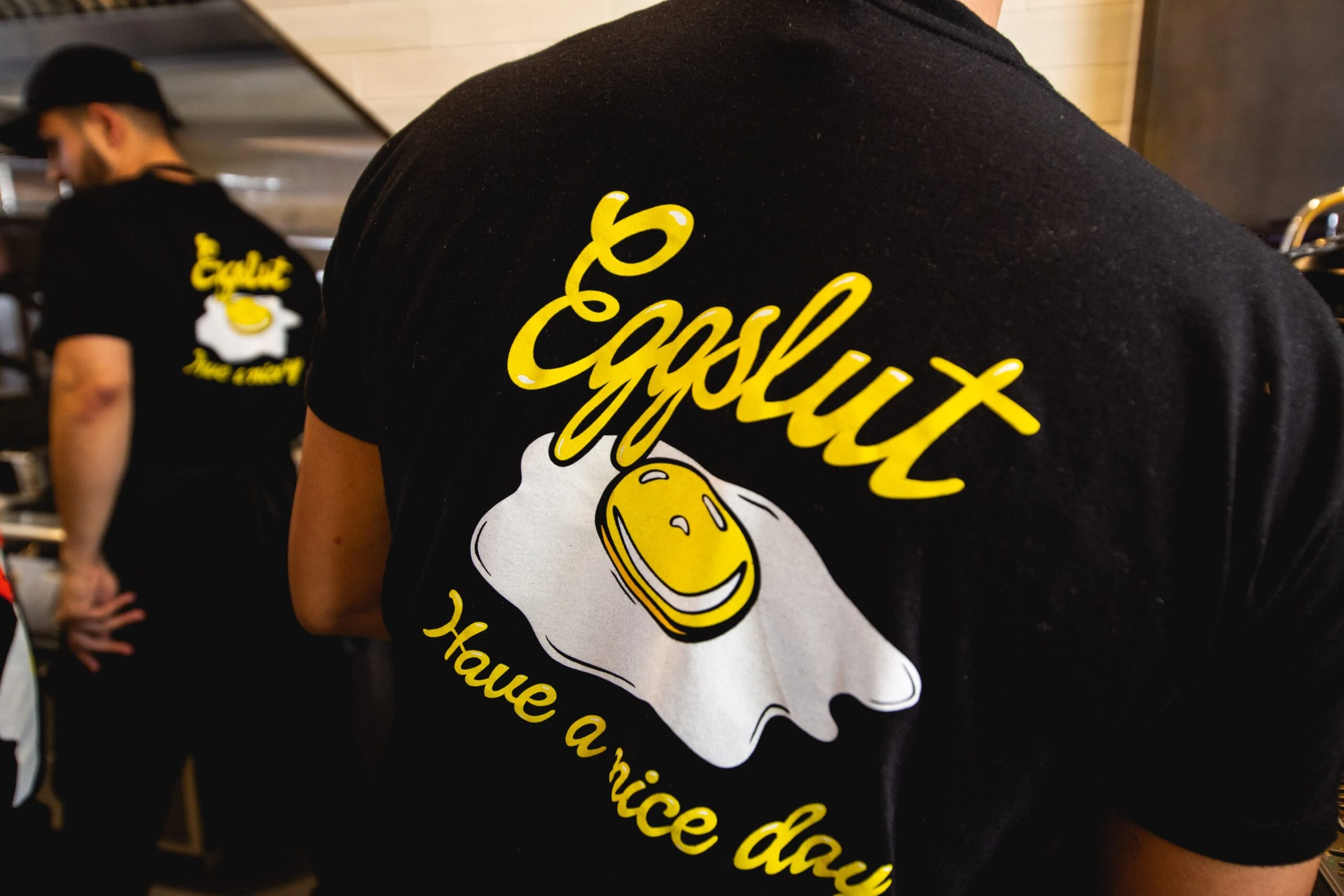 Eggslut x HBO: Eggslut staff wearing the back-print t-shirt in the kitchen